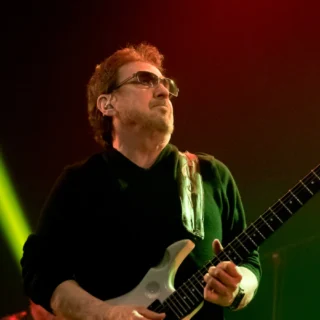 Buck Dharma playing his guitar at Wacken Open Air in 2016; the lower guitar body is outside the original frame.
