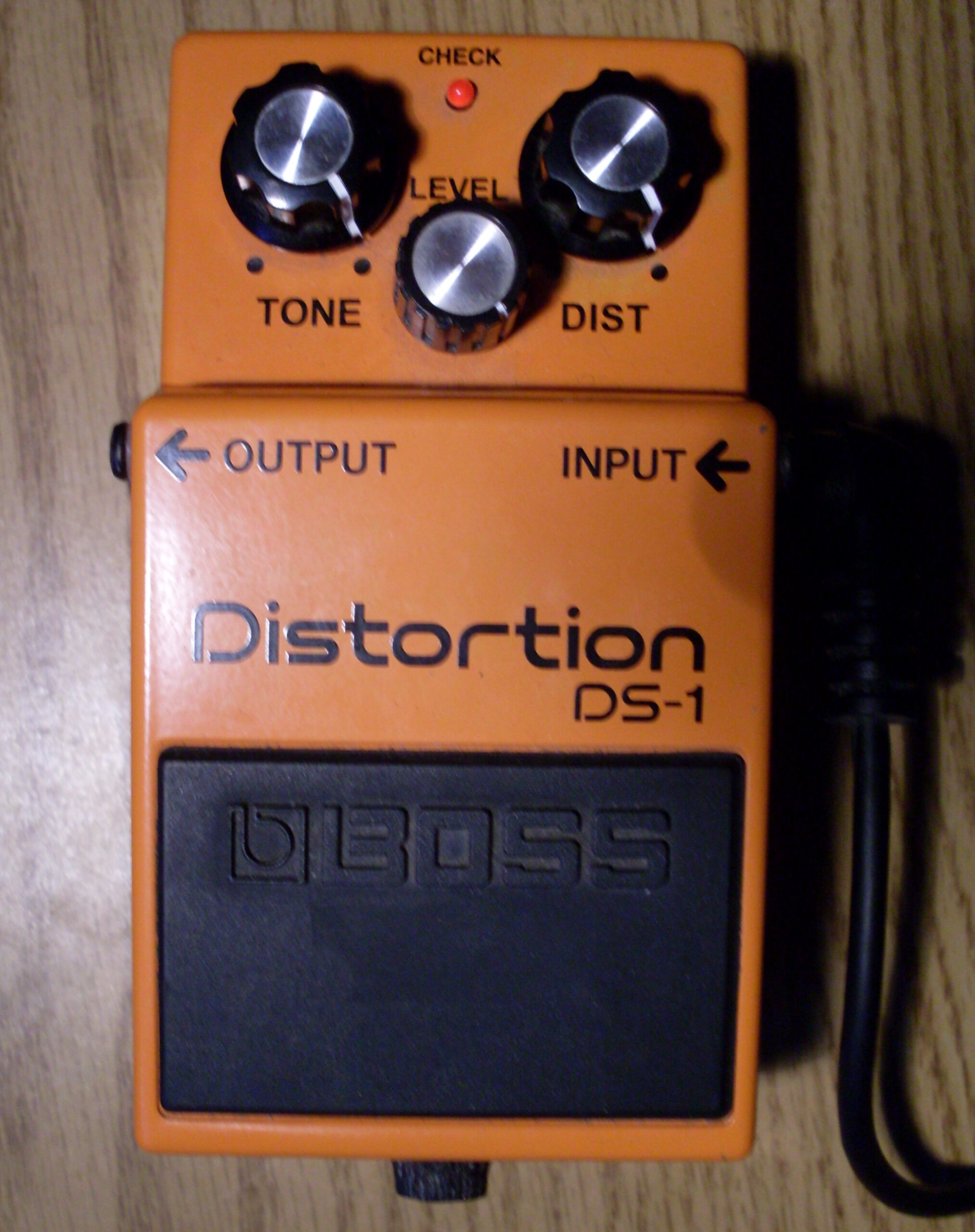 Orange Boss DS-1 Distortion pedal with Tone, Level and Dist controls.