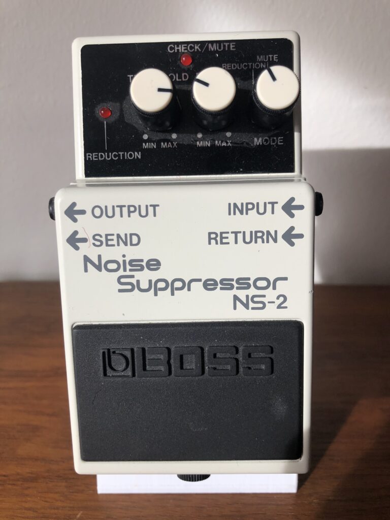 White Boss NS-2 Noise Suppressor pedal with threshold, decay and mode controls and four side jacks.