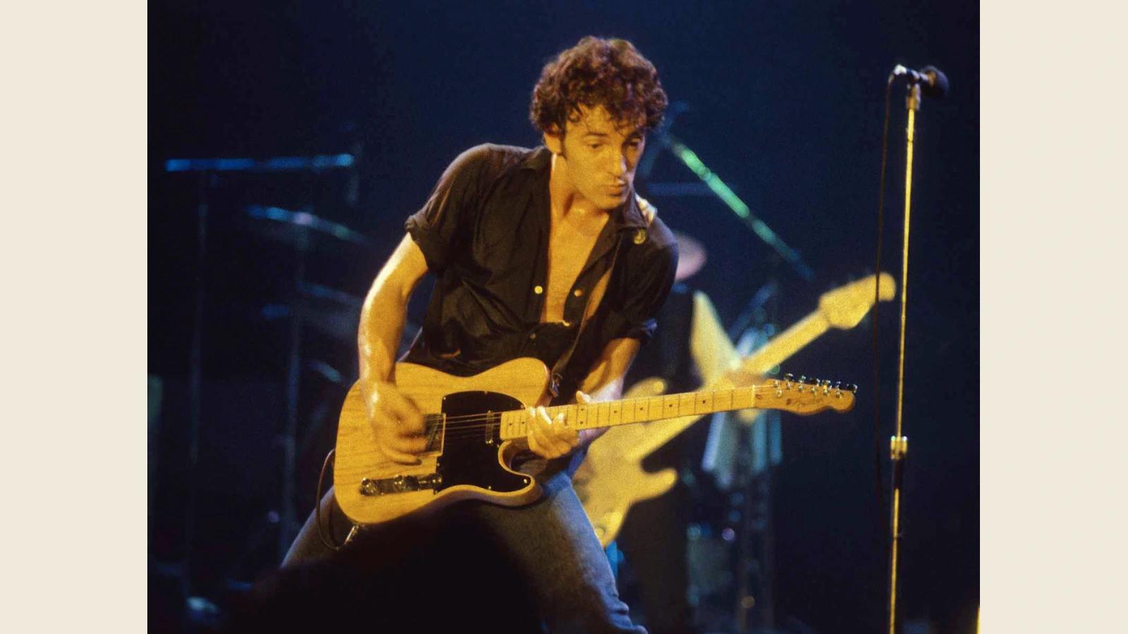 Bruce Springsteen playing a blonde electric guitar at New Haven Coliseum, circa 1977–1978