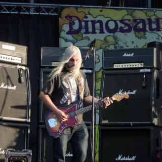 J Mascis playing an electric guitar onstage at Optimus Primavera Sound in 2013.