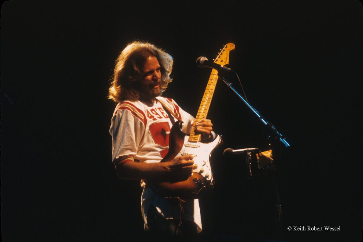 Don Felder playing a Fender Stratocaster on stage.