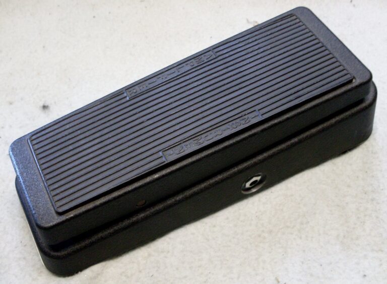 A complete black Dunlop Crybaby wah pedal photographed at an angle, with treadle and side jack visible.
