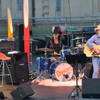 Dwight Yoakam playing an acoustic guitar with musicians at the San Diego County Fair in 2008.