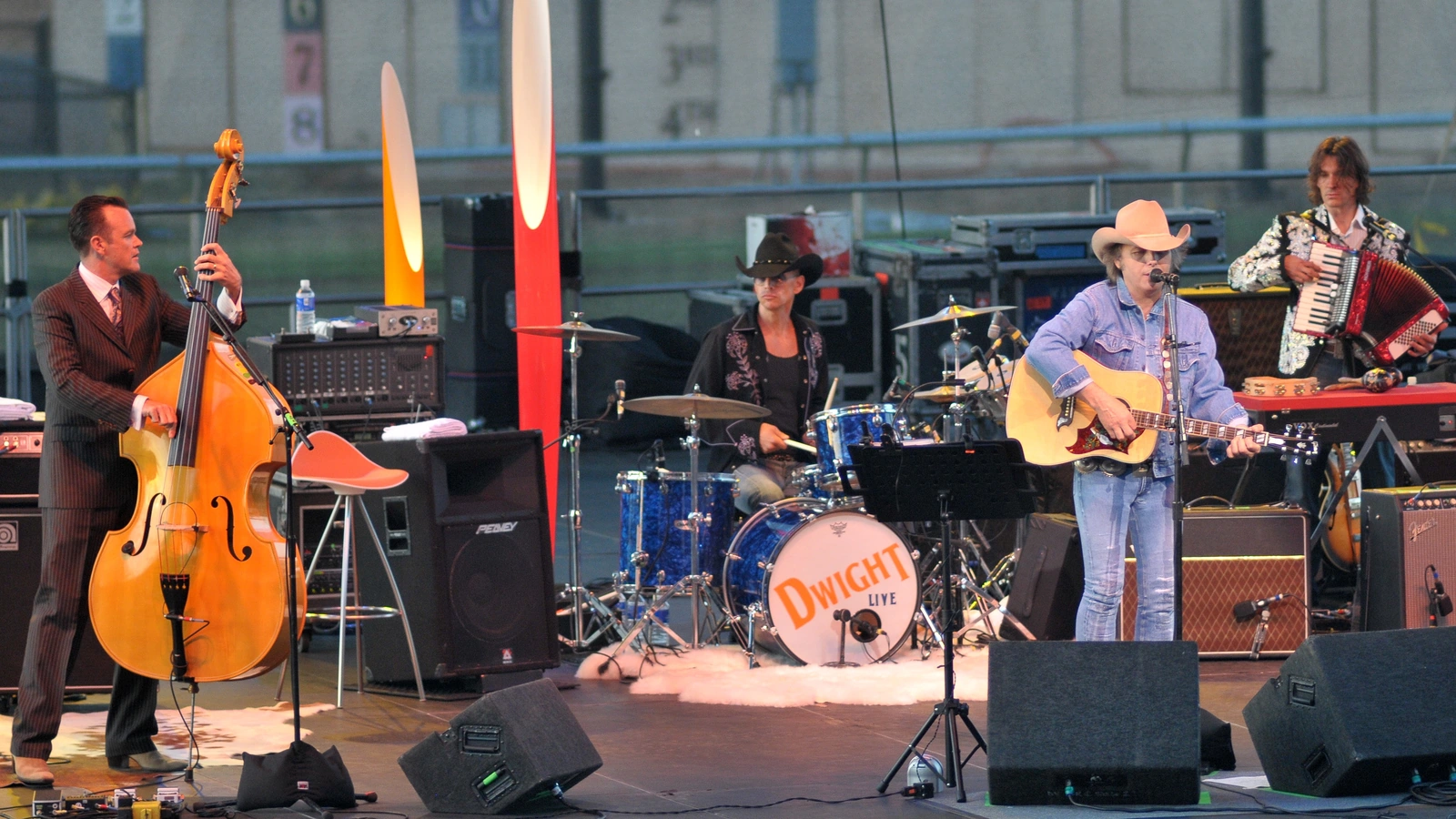Dwight Yoakam playing an acoustic guitar with musicians at the San Diego County Fair in 2008.
