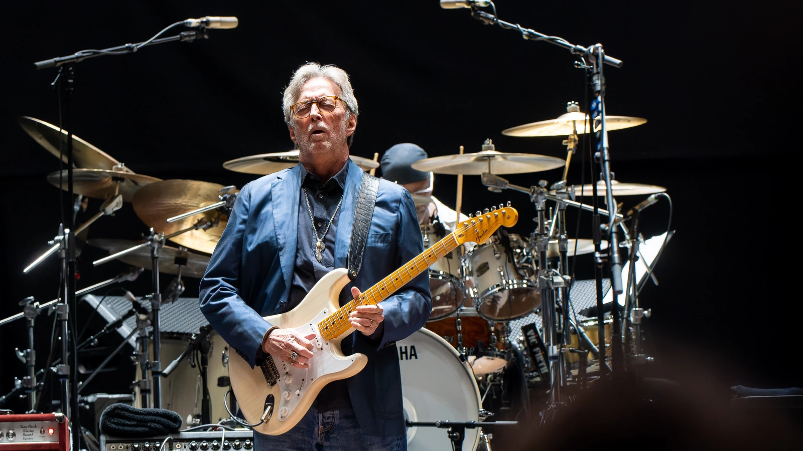 Eric Clapton playing a cream electric guitar at the Royal Albert Hall in 2023.