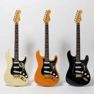 Olympic White, Orange and Black Fender Dark Horse Records Stratocasters with gold hardware