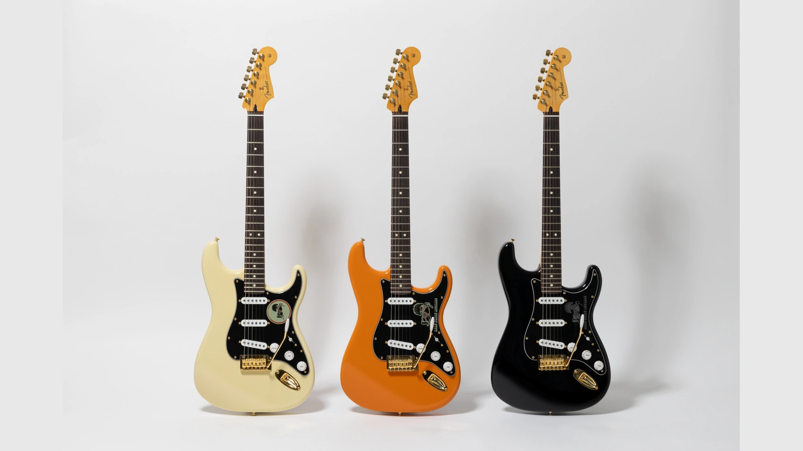 Olympic White, Orange and Black Fender Dark Horse Records Stratocasters with gold hardware