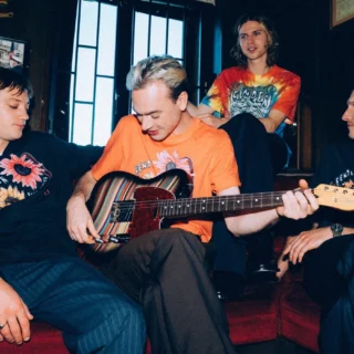 The four members of Legss pictured with the striped Fender and Paul Smith Telecaster in the collaboration campaign.