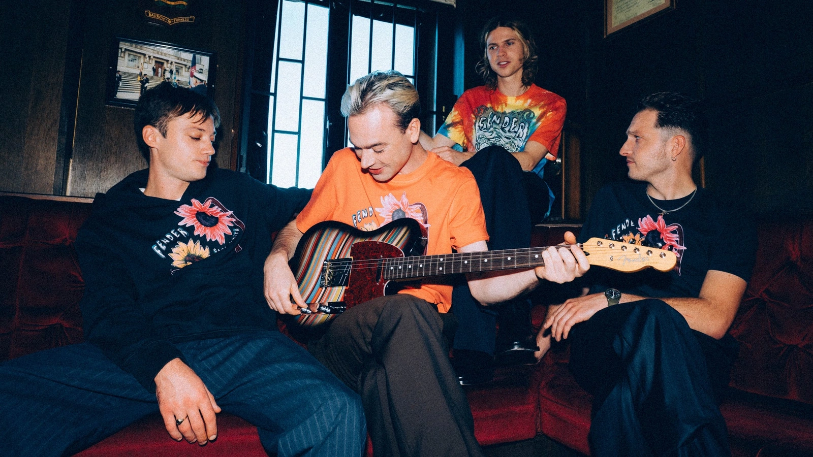 The four members of Legss pictured with the striped Fender and Paul Smith Telecaster in the collaboration campaign.