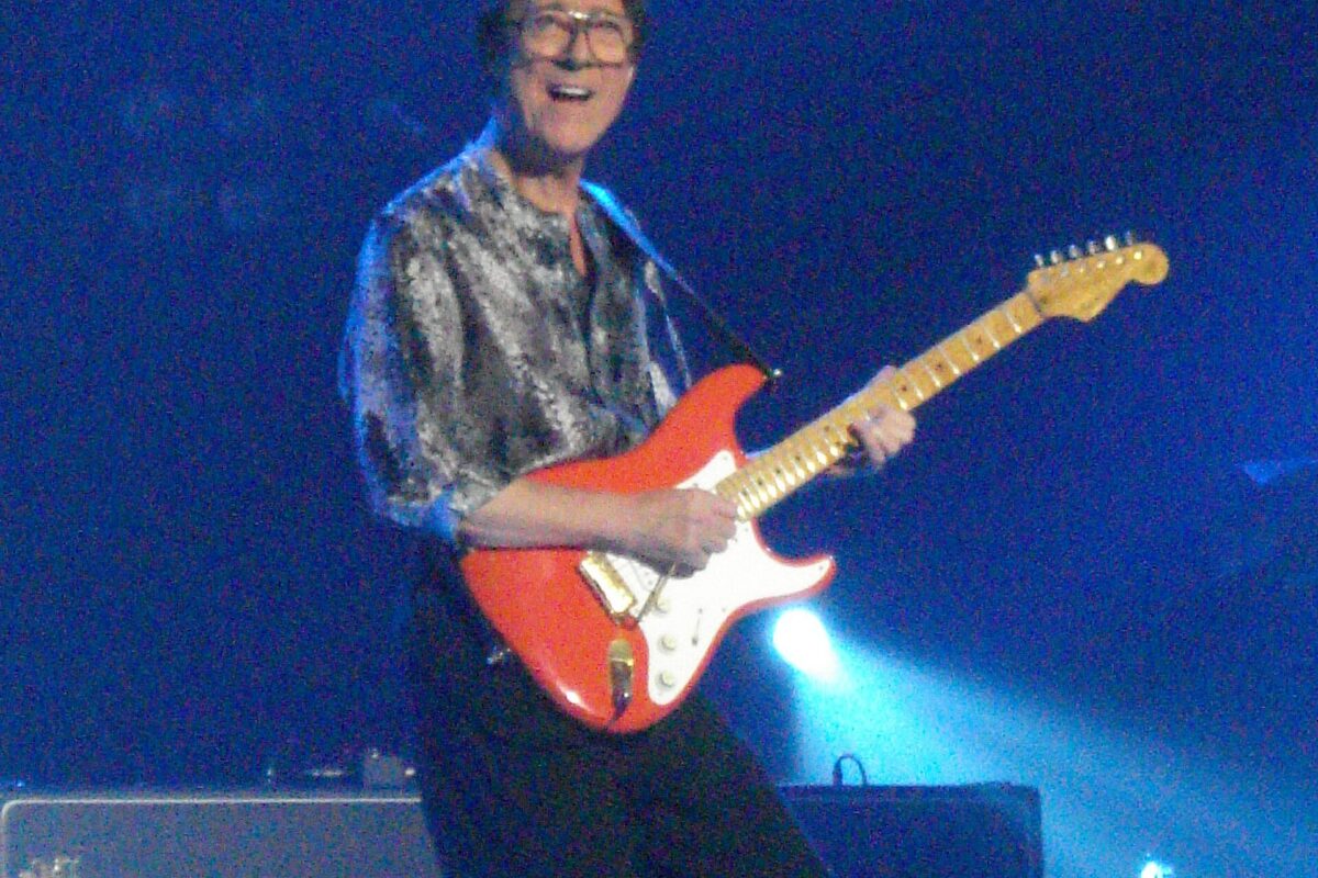 Hank Marvin playing a red Stratocaster on The Shadows' 50th anniversary tour in 2009.