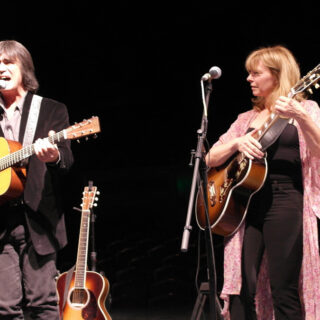 Larry Campbell and Teresa Williams performing with acoustic guitars in Lakewood, New Jersey, in 2014