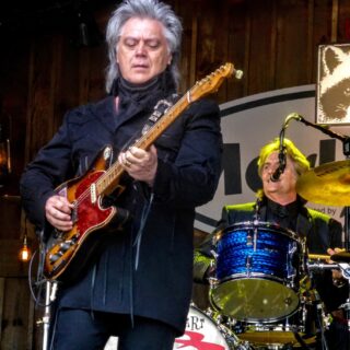 Marty Stuart playing guitar at MerleFest in 2017.