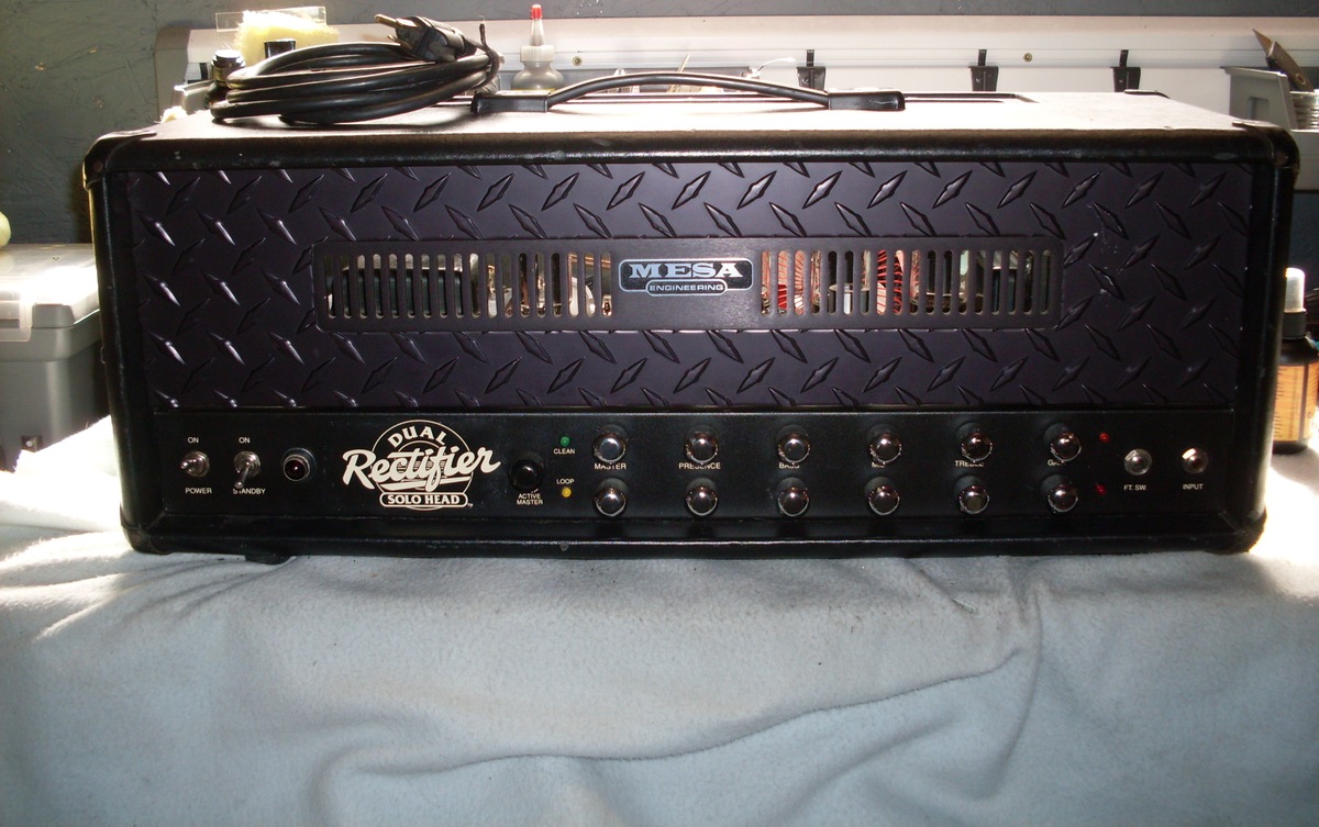 A black Mesa/Boogie Dual Rectifier Solo Head with its full enclosure, handle and two rows of controls visible.