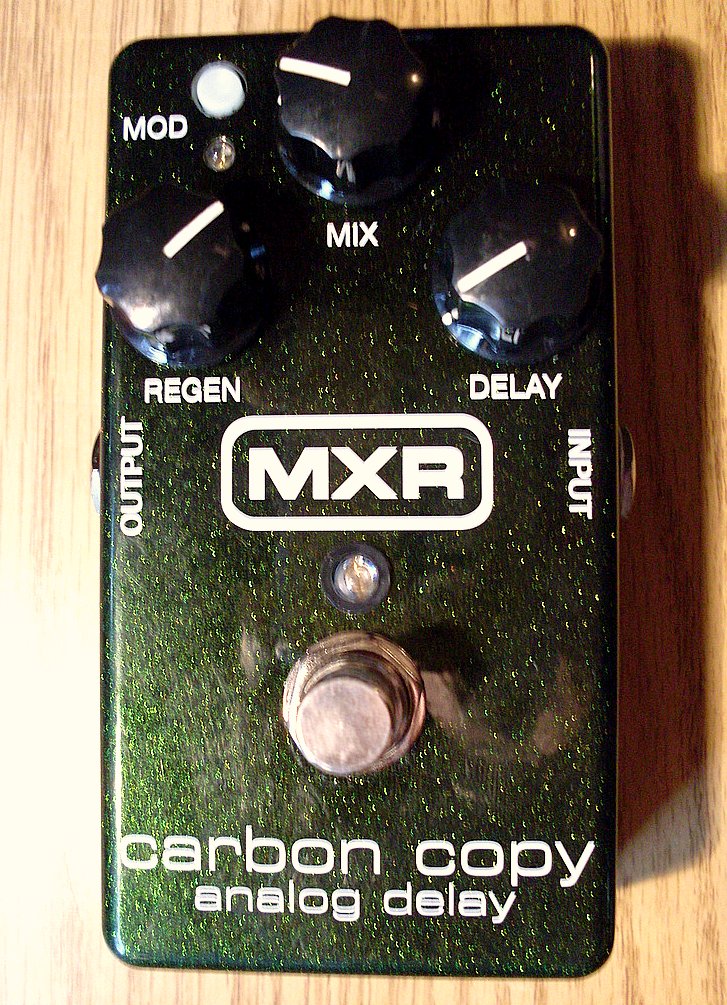 A green MXR Carbon Copy analog delay pedal showing all three knobs, modulation button and footswitch.