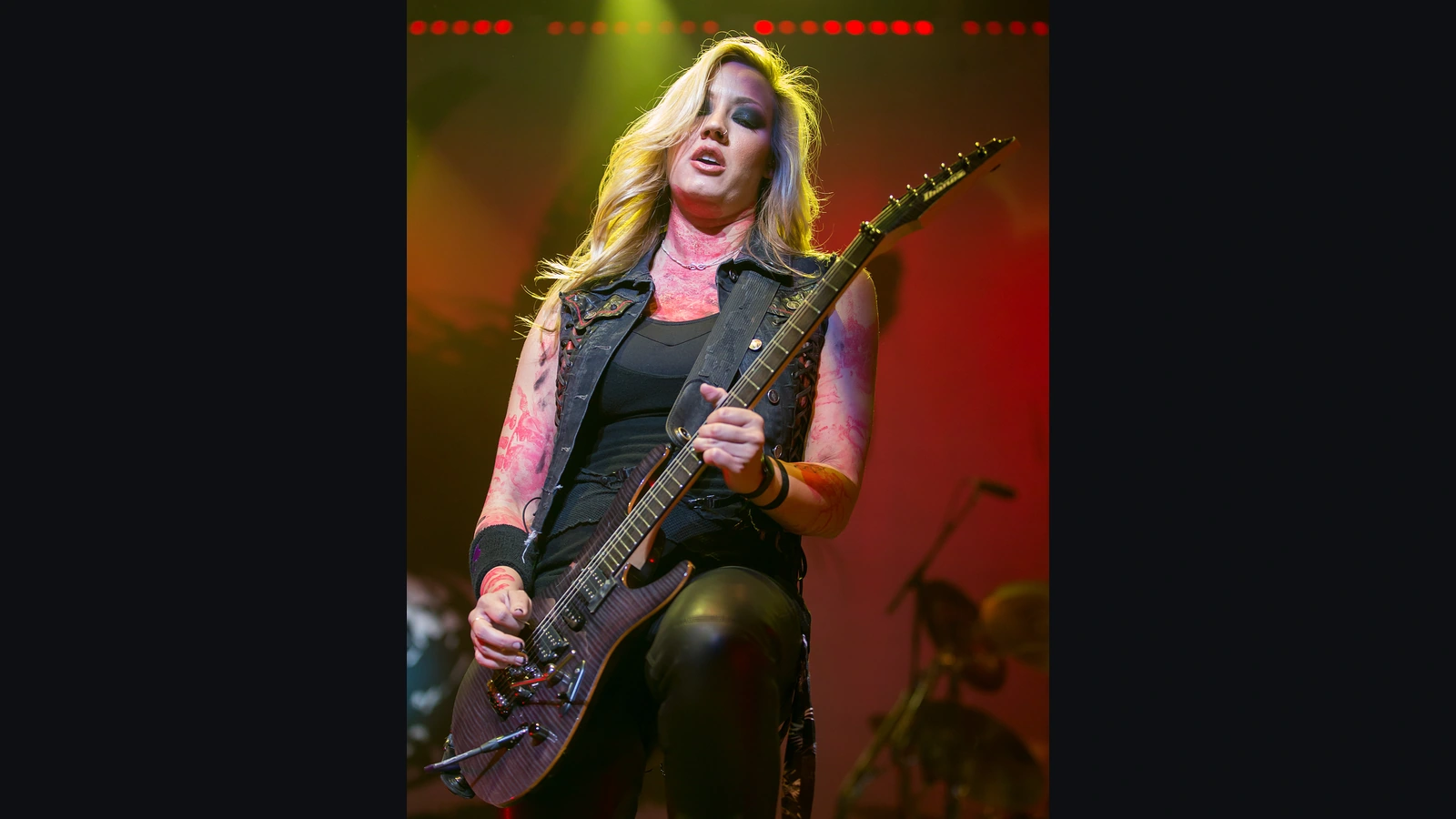 Nita Strauss playing an Ibanez electric guitar during an Alice Cooper concert in San Antonio in 2015.