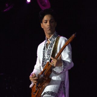 Prince playing guitar at Coachella in 2008