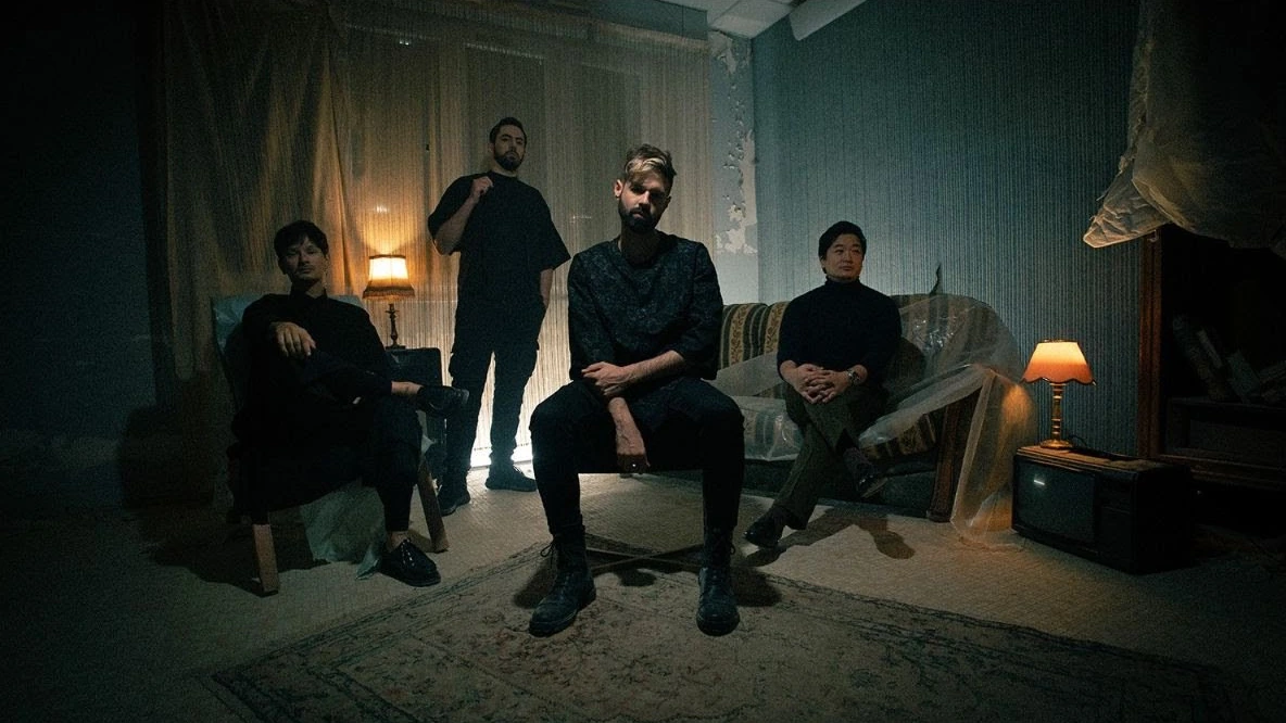The four members of REVNOIR in a promotional band photograph