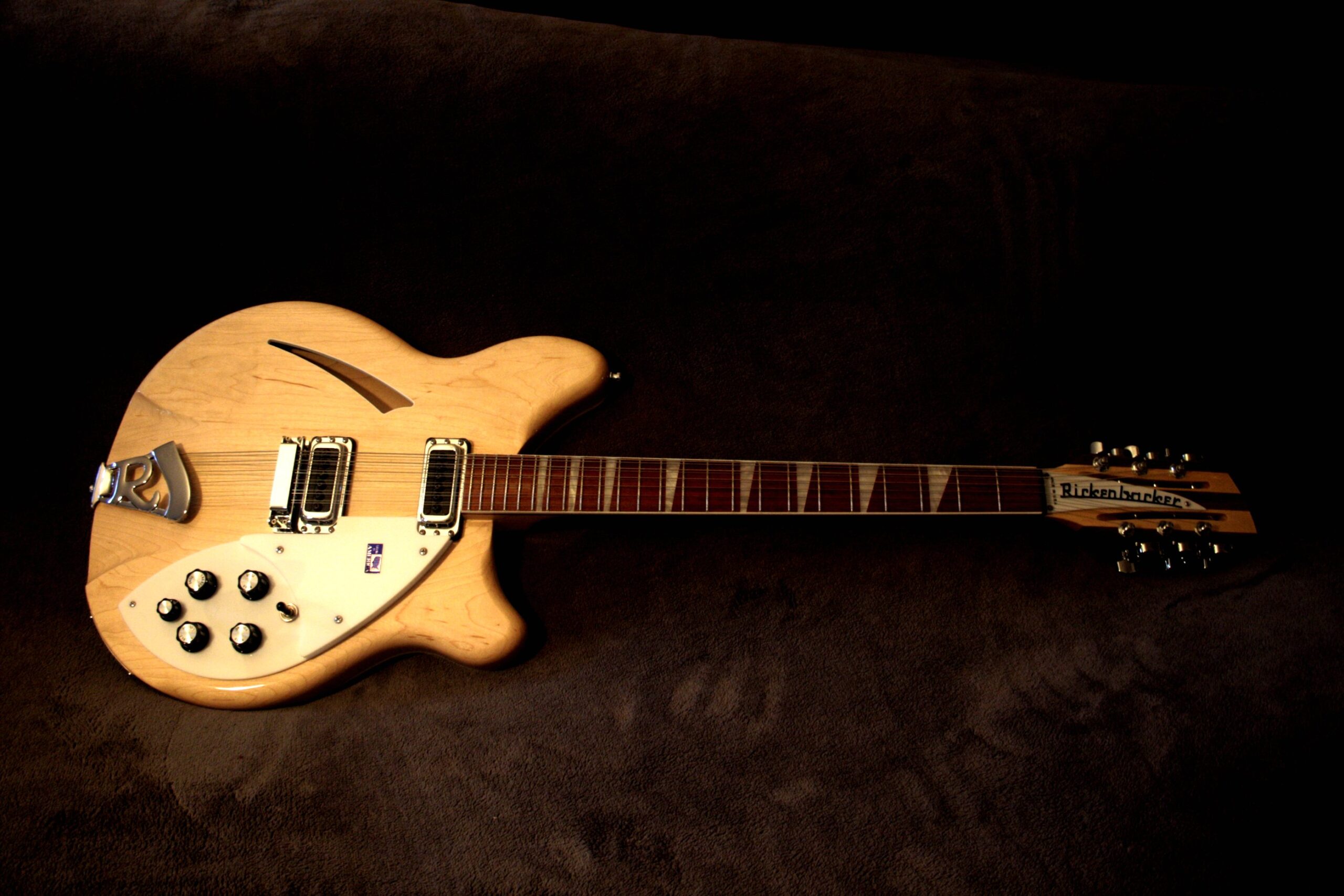 Natural-finish Rickenbacker 360/12 twelve-string electric guitar, shown complete on a dark surface.
