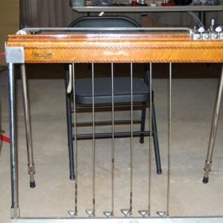 Archival 2008 photograph of a wooden Sho-Bud pedal steel guitar with its pedal rods and legs visible.