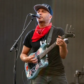 Tom Morello performing with his blue electric guitar in Bristol in 2019.
