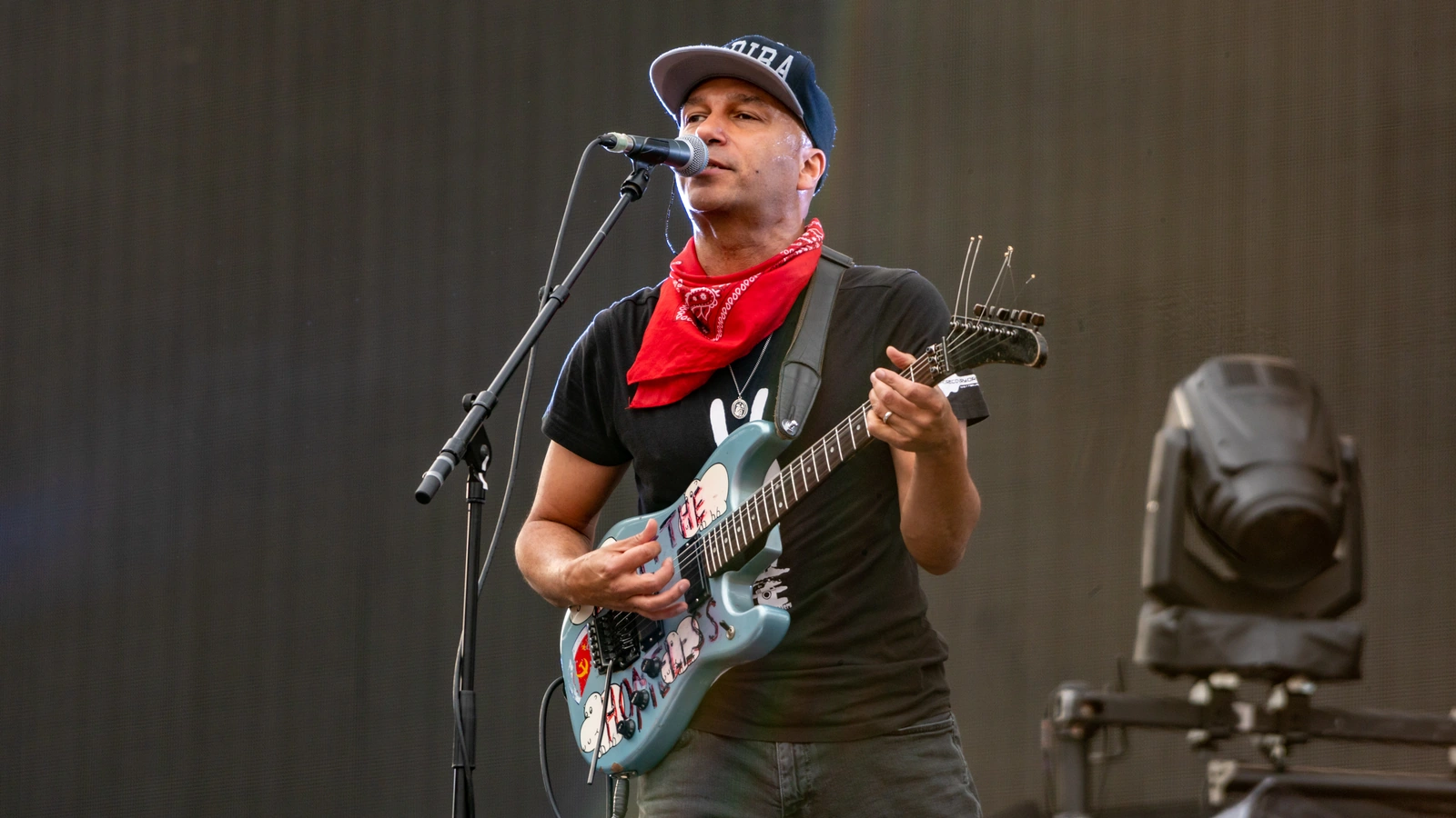 Tom Morello performing with his blue electric guitar in Bristol in 2019.