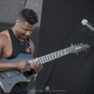 Tosin Abasi playing an eight-string Ibanez guitar with Animals as Leaders at Knotfest México in 2016